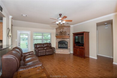 Family Room with fireplace and wood look tile floo