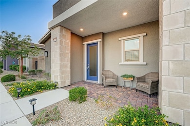 Entrance to property with stucco siding and a pati