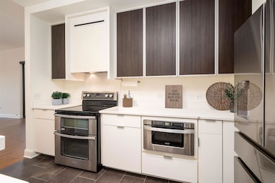 Kitchen featuring refrigerator, oven, white cabine