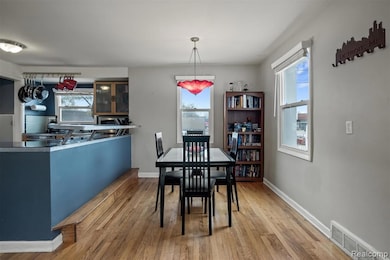 Dining room with light wood finished floors and baseboards