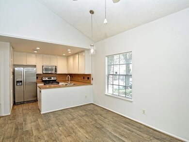 Kitchen with a sink, dark wood-style flooring, st