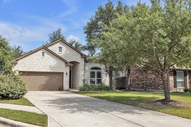 French provincial home with a garage, driveway, a