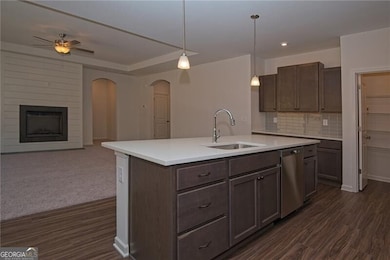 Kitchen featuring open floor plan, light counterto