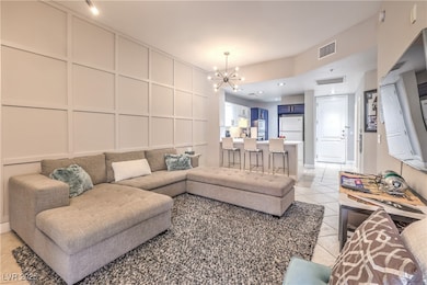 Living area with a decorative wall, light tile pat