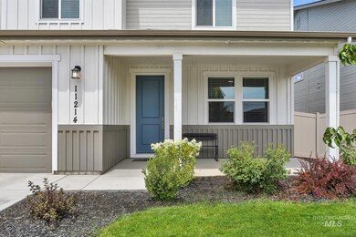 View of exterior entry featuring a porch and board and batten siding