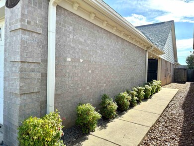 View of side of property featuring roof with shingles and brick siding