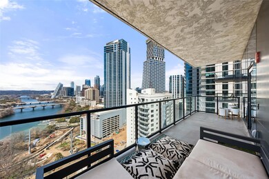Balcony featuring a water view and a city view