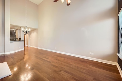 Unfurnished living room featuring a high ceiling,
