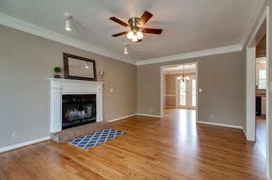 Nice trim and moldings throughout the home.  This living room features a wood burning fireplace.
