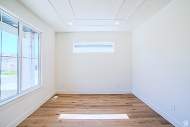 Empty room with light wood-type flooring and recessed lighting