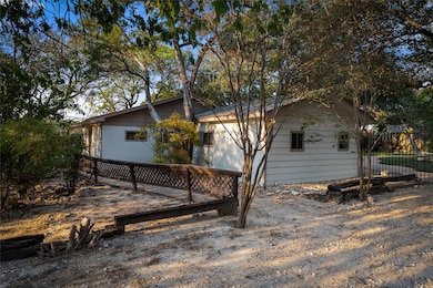 View of side of home with a wooden deck