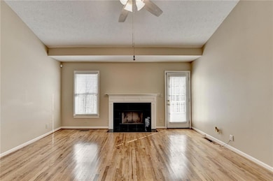 Unfurnished living room featuring visible vents, b