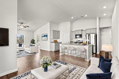 Living room featuring baseboards, recessed lightin