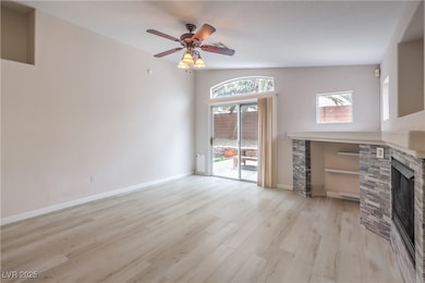 Unfurnished living room with a fireplace, light wo