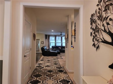 Hallway featuring recessed lighting and baseboards