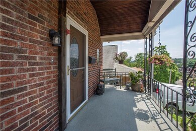 This charming covered front porch welcomes you hom