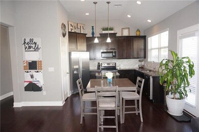 Kitchen with stainless steel appliances, dark bro