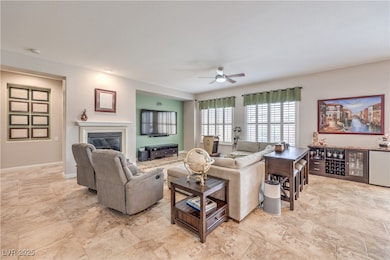 Living area featuring a glass covered fireplace, b