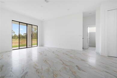 Empty room featuring light marble finish flooring
