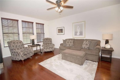 family room with neutral decor, gorgeous wood floo