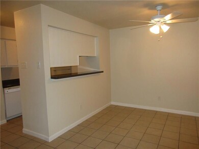 Tiled empty room with ceiling fan
