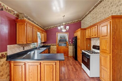 Kitchen with white gas range oven, dark countertop