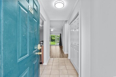 Entryway featuring ceiling fan, a textured ceiling