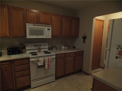 Open kitchen with ample oak cabinets. All applianc