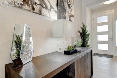 Entrance foyer featuring plenty of natural light, light wood-style floors, and a textured wall