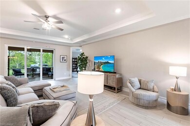 Living room featuring crown molding, light hardwoo