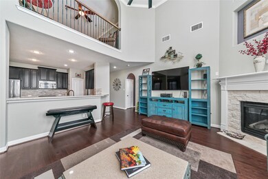 Another view from the gathering area with open concept chefs kitchen and custom iron balcony.