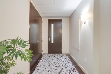 Entryway with dark wood-style flooring and elevator