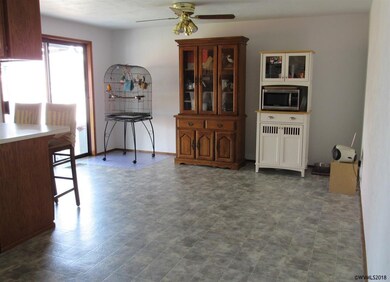 Dining room/kitchen area with seating at counter.C
