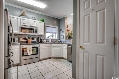 Kitchen featuring white cabinets, a textured ceili