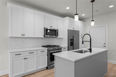 Kitchen with light wood-type flooring, visible ven