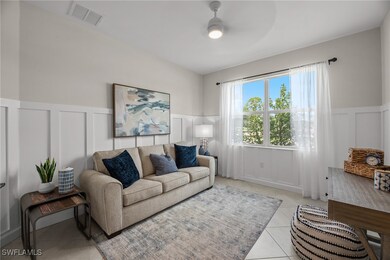 Living room featuring a decorative wall, a ceiling