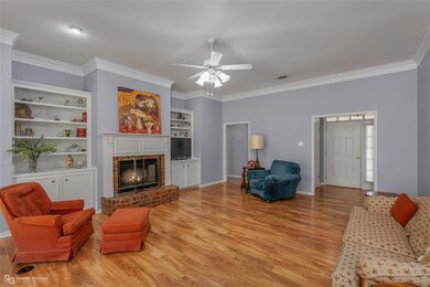 Living room featuring ornamental molding, a brick 