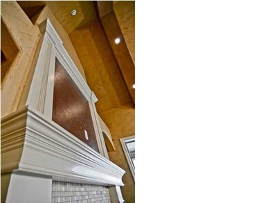 The custom fireplace draws the eye up to the soari