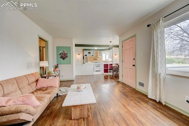 Living room featuring wood finished floors, visibl