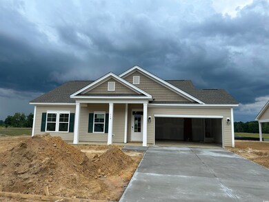 View of front facade with a garage, driveway, a porch, and a shingled roof