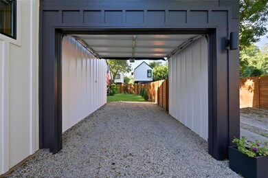 View of parking / parking lot featuring fence and