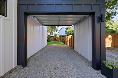 View of parking / parking lot featuring fence and