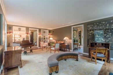 Living room entry is framed with bookcases to disp