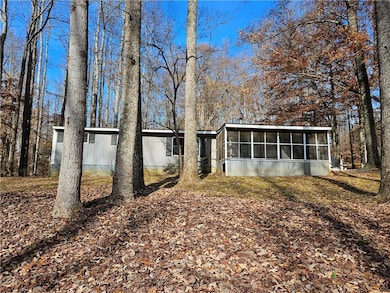 Back of property featuring a sunroom