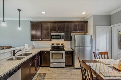 Kitchen with light stone counters, light wood-type