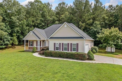 View of front of house featuring concrete driveway, an attached garage, a front lawn, and a porch