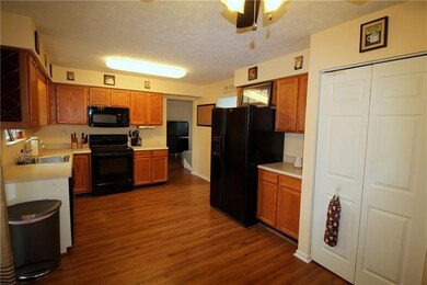 The wood laminate flooring flows throughout the fi