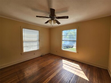 Unfurnished room featuring crown molding, dark har
