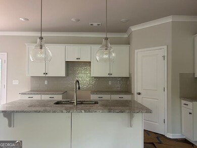 upgraded cabinets counter top, large Island, Pendent lights tile backsplash