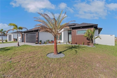 View of front of home with driveway, a garage, and